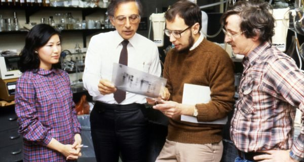 three men standing beside woman