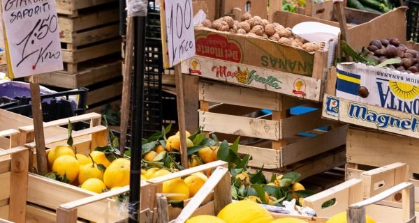 a bunch of crates filled with lots of fruit