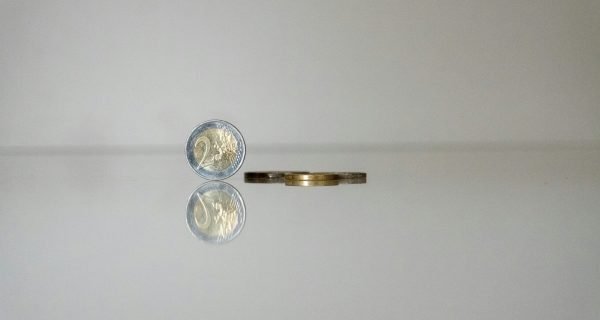 a gold ring with a coin on top of it