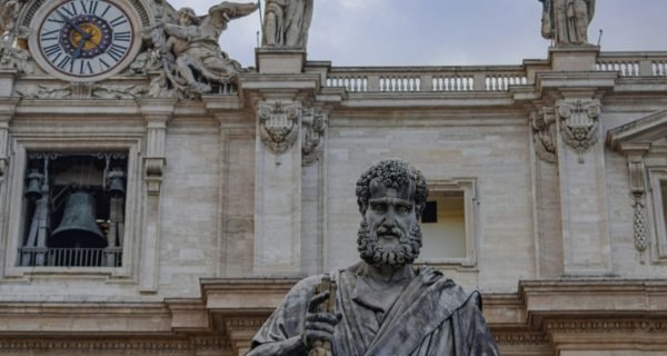 man holding weapon statue