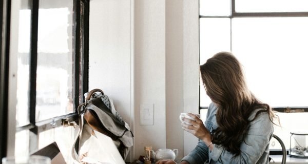 man holding white ceramic teacup