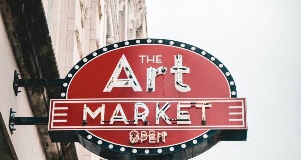 a red sign hanging from the side of a building