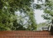 a red tiled roof with trees in the background