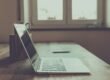 macbook pro on brown wooden table