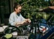 a woman sitting at a table with a laptop