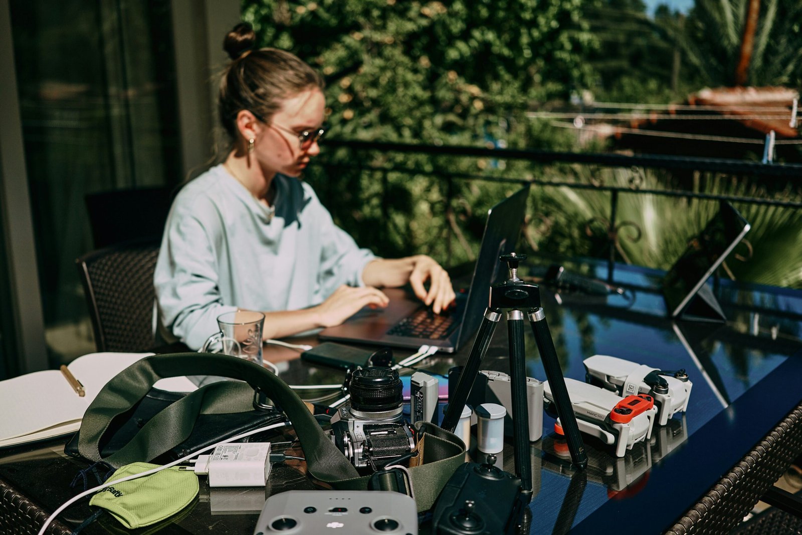 a woman sitting at a table with a laptop