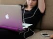 woman sitting on sofa with MacBook Air