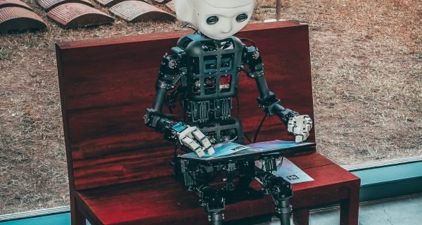 black and white robot toy on red wooden table