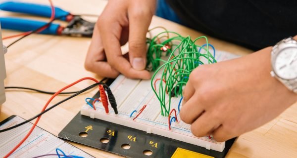 person holding black and white audio mixer