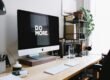 silver iMac with keyboard and trackpad inside room